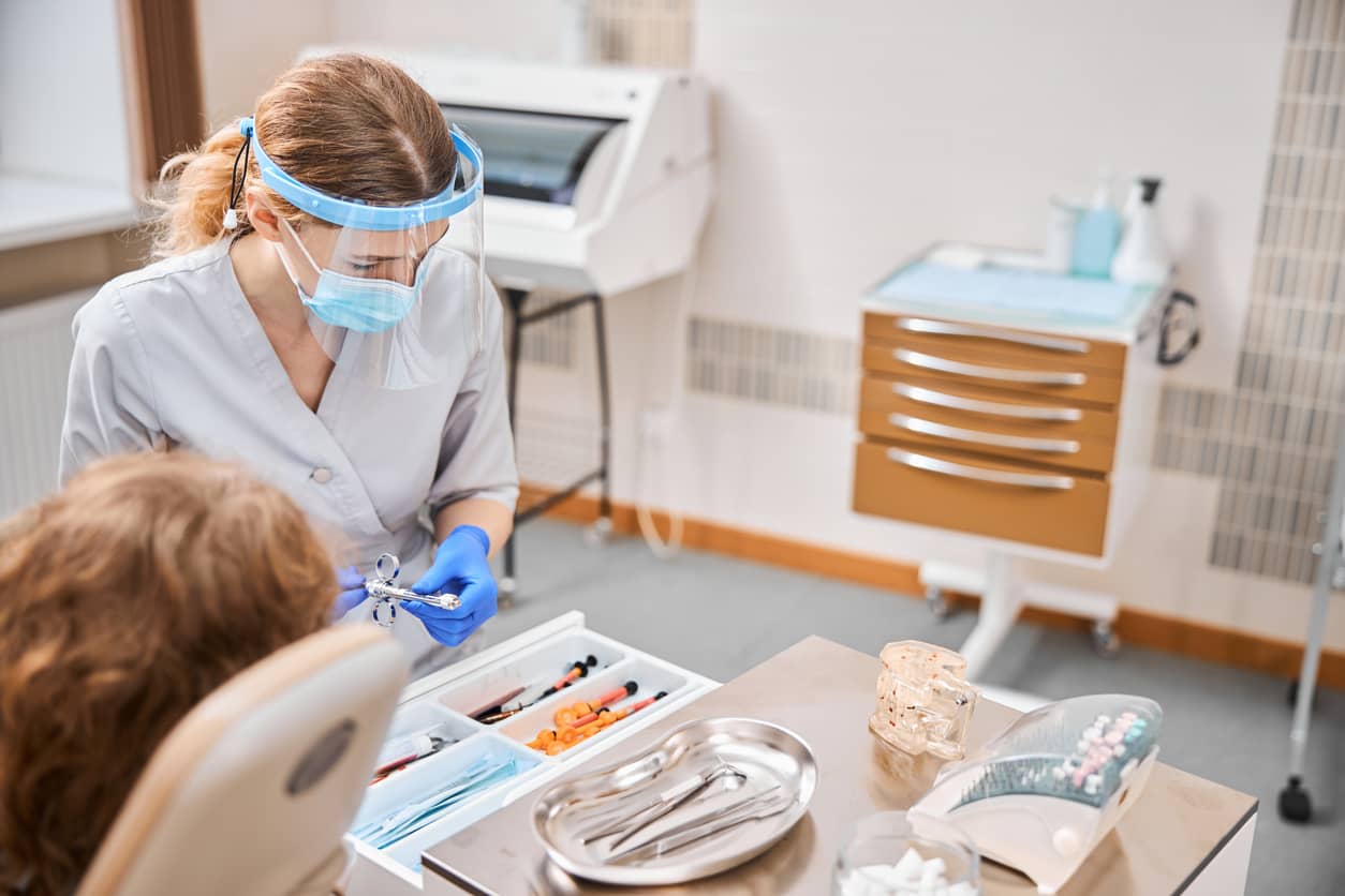 dental assistant working with patient